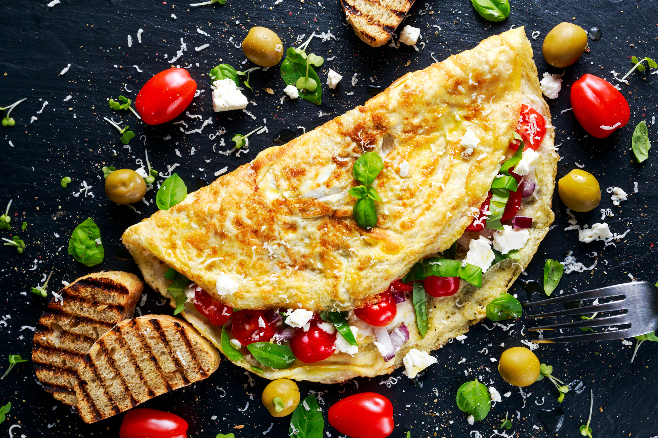 Vegetables Omelette with tomatoes, basil, greek cheese, parmesan, olives, toast.