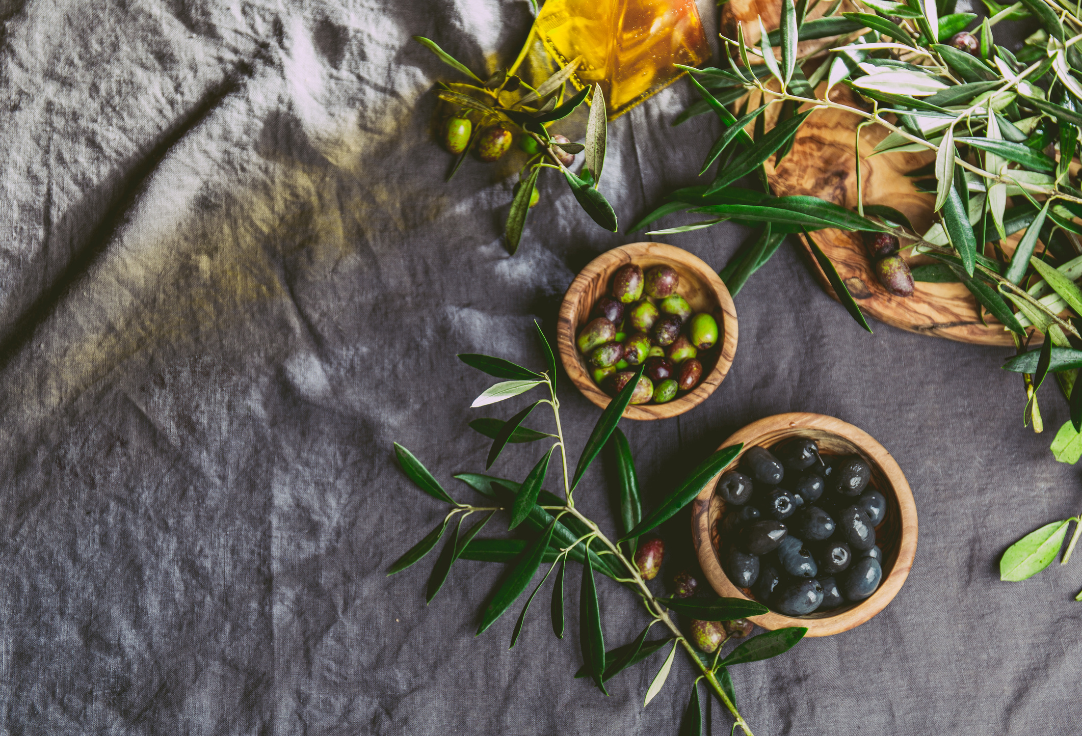 OLIVES. Olives, olives tree branch. olive oil on linen tablecloth